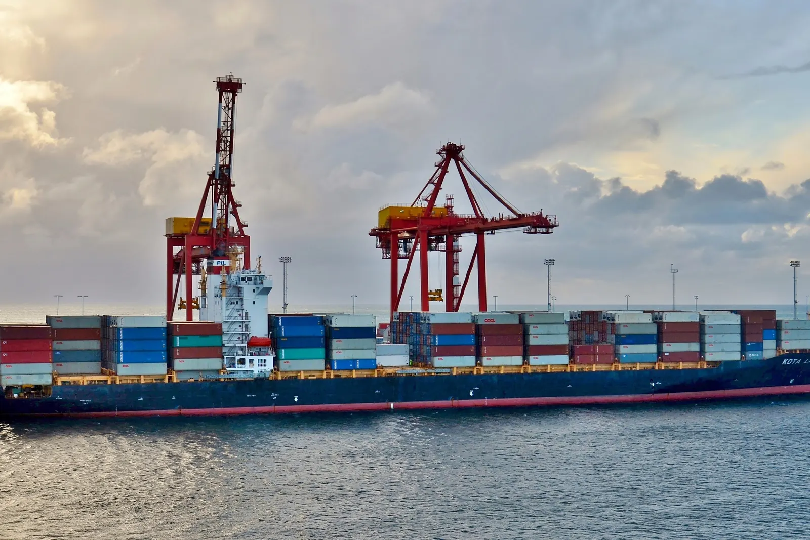 Container ship berthed under gantry cranes at Fremantle container terminal, Western Australia